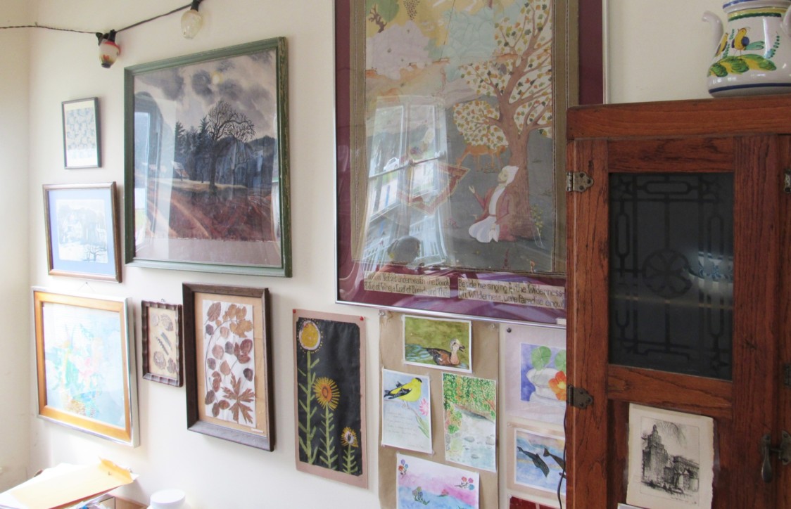 A collection of prints, paintings, and photographs hang above Darr’s kitchen table. Photo by Avery Gregurich.