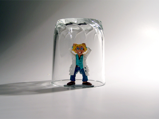 Female doctor figurine tugging on her hair while trapped under a glass cup.