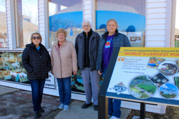 Shirley Phillips, Shelly Crump, Milo Lines and Rhonda Lines stand in front of the World’s Largest Popcorn Ball they helped create in the small town of Sac City, Iowa.