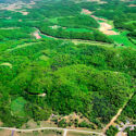 A birds-eye view of a forest and various roads spread out across the land.