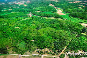 A birds-eye view of a forest and various roads spread out across the land.
