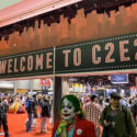 The C2E2 sign is above a crowd of people entering and exiting the event space.