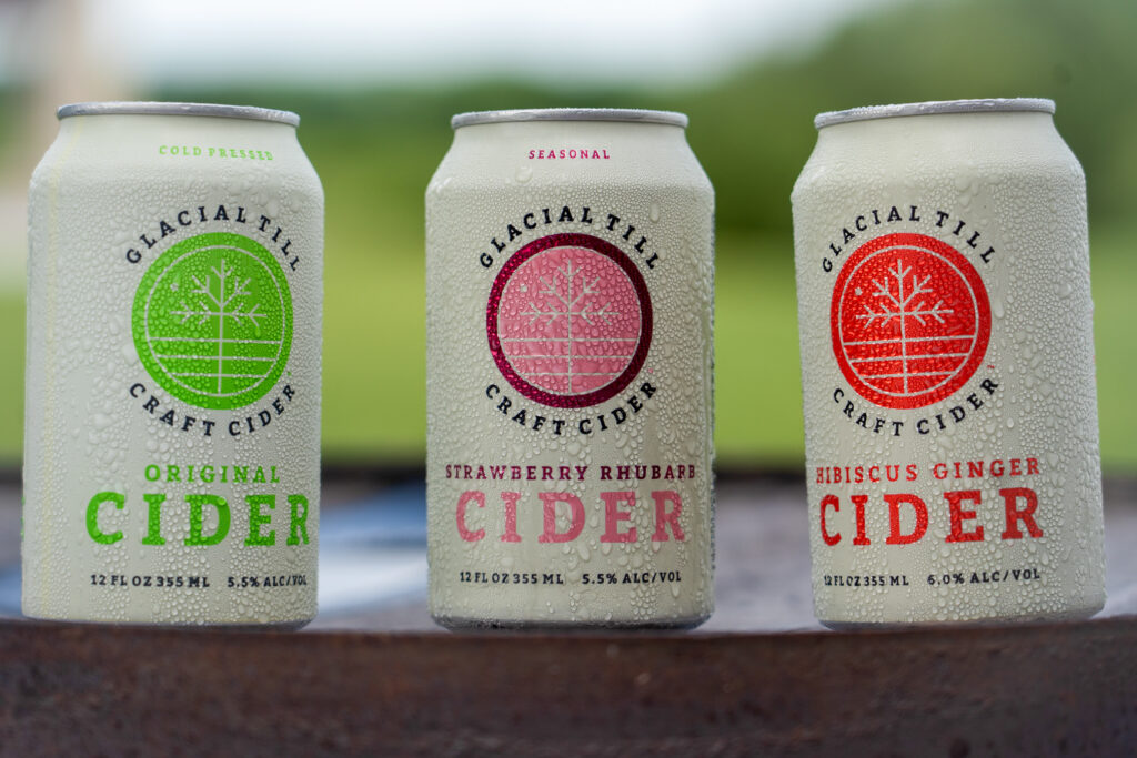 Glacial Till cider cans in original, strawberry rhubarb and hibiscus ginger.
