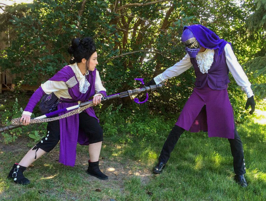 Gregory Parks and his wife sport their mashup cosplay featuring a Purple Rain inspired Kylo Ren and Rey Skywalker.  
