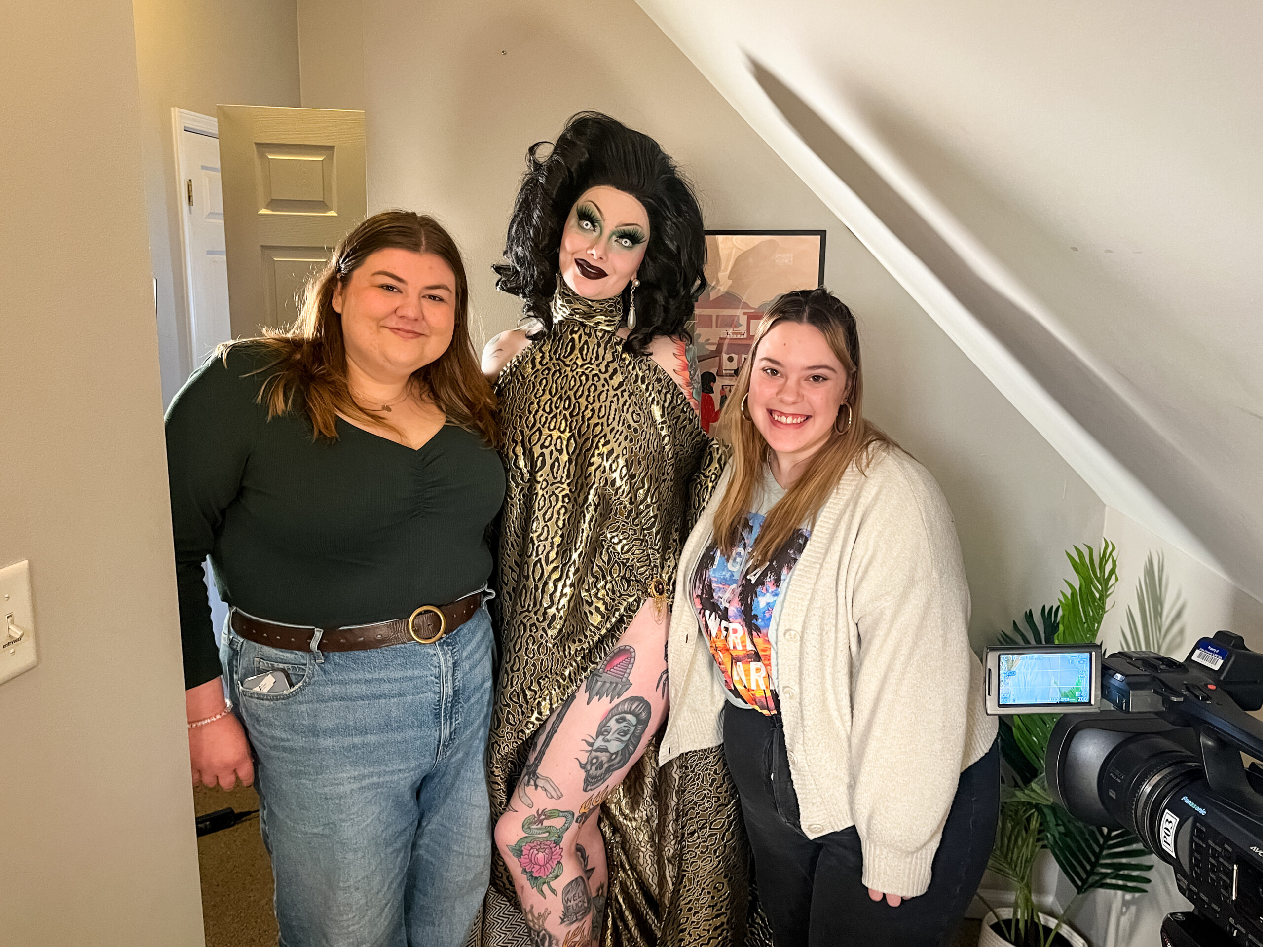 Urban Plains staff members Kathryn Pagel and Natalie Novak stand with Sigourney Beaver, who is dressed in full drag.